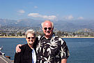 mom and dad standing on the pier of santa barbara